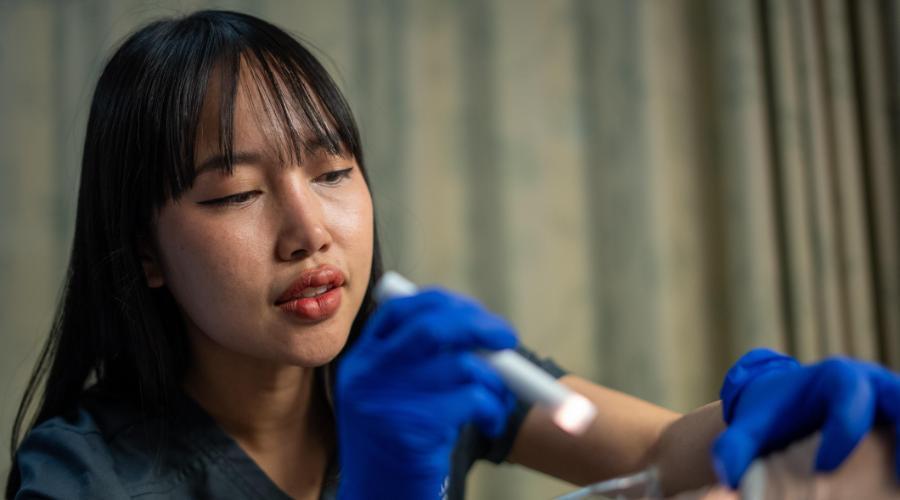 Nursing student doing patient skills on person