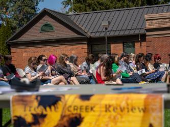 Attendees gather for the 2023 launch of the Trestle Creek Review on May 2, 2023, on the lawn between the Eisenwinter Soccer Field and Boswell Hall on NIC’s Coeur d’Alene campus.