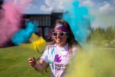 Elli Michael, North Idaho College marketing and events coordinator, runs through colorful powder during a trial exercise in preparation for the inaugural North Idaho College Color Fun Run on Saturday, Aug. 23.