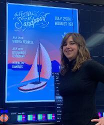 North Idaho College sophomore Gracie Duncan, a Timberlake High graduate, stands in front of her winning poster design for The Festival at Sandpoint. Her design will be featured on festival lineup posters, in advertisements, on a Toyota Tacoma wrap that will showcase the festival, the festival’s website and other marketing materials.